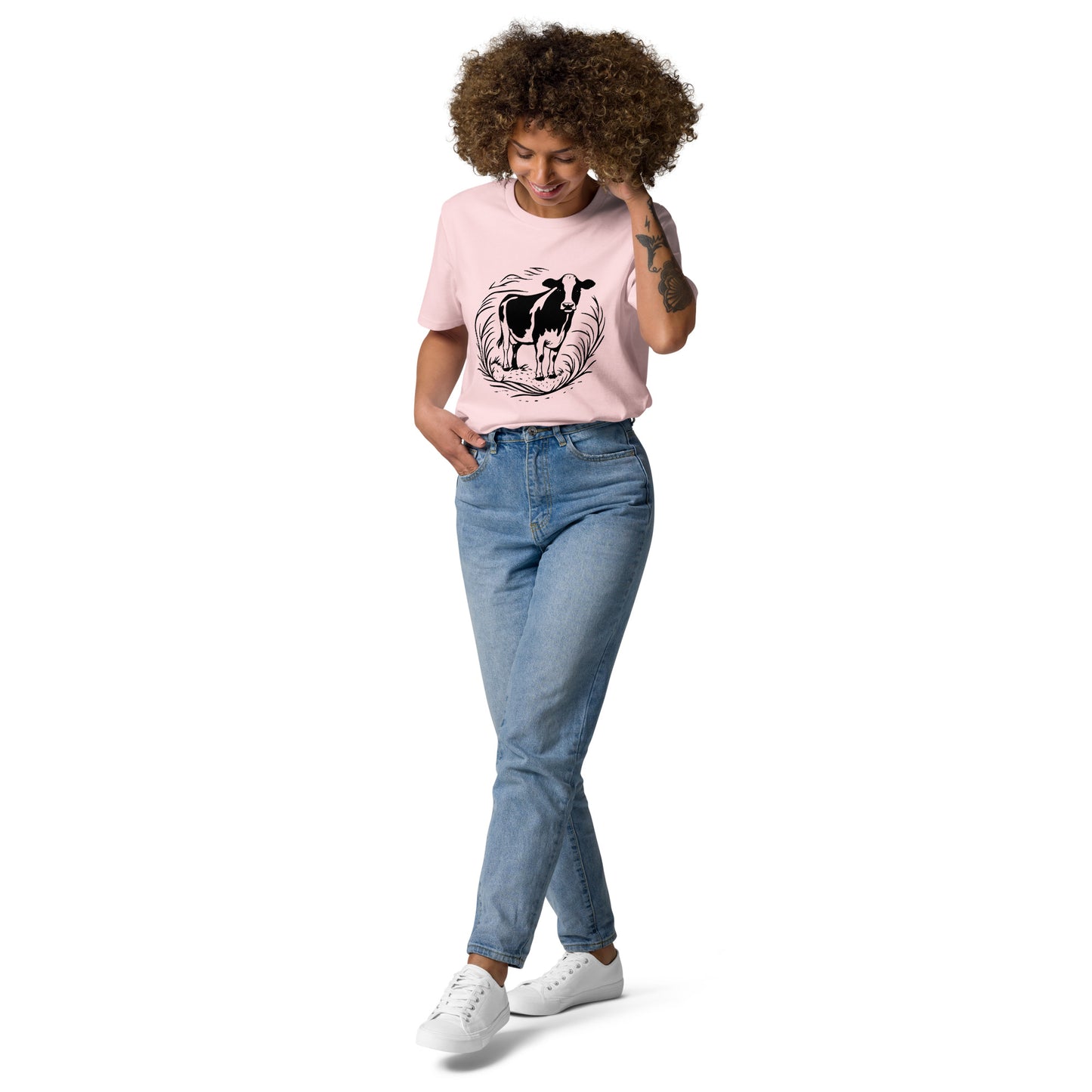 Lifestyle photo of Moving Forward organic cotton T-shirt with cow illustration – unisex tee – color: cotton pink