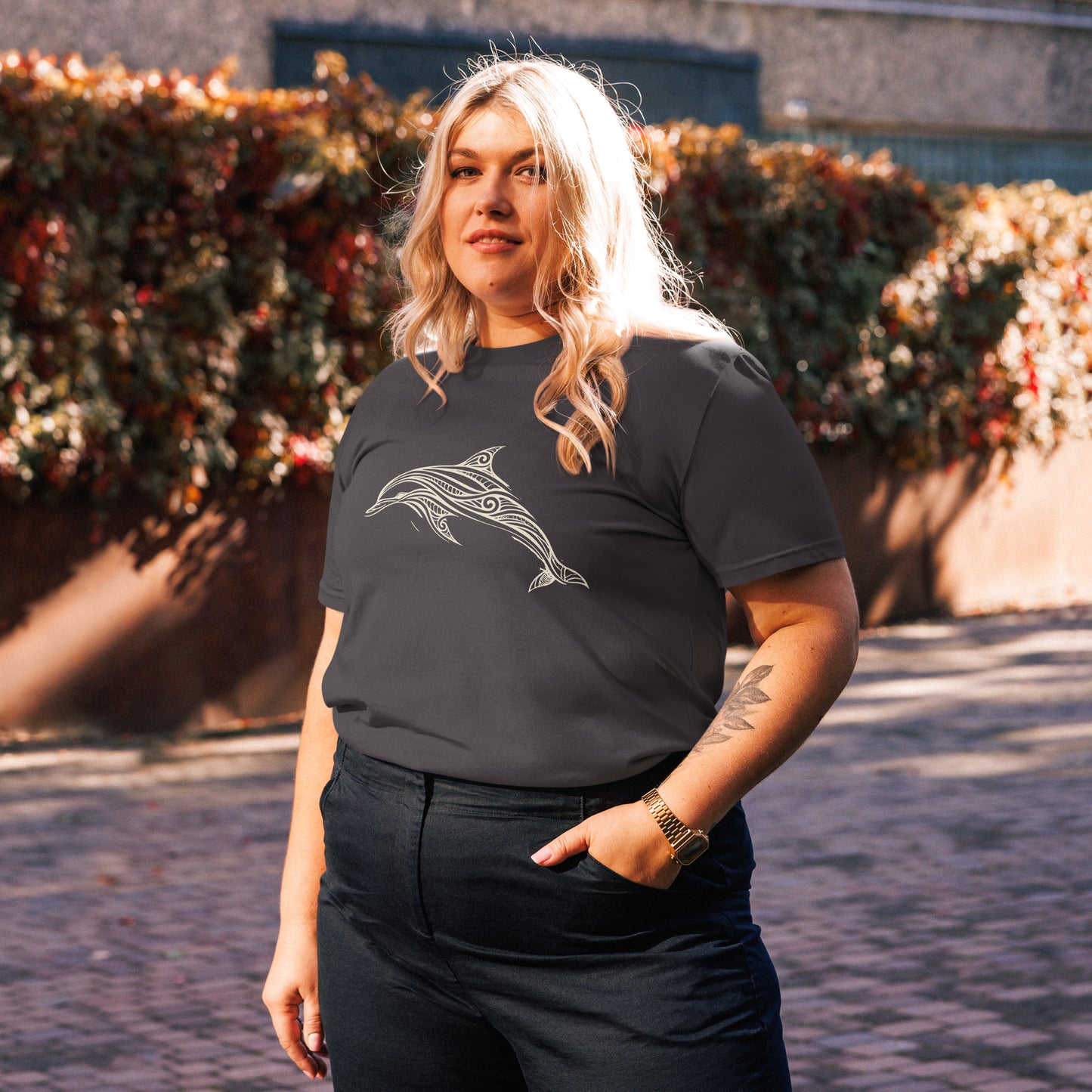 Lifestyle photo of Organic cotton t shirt featuring minimalist line art dolphin inspired by the Celtic Sea off West Cork. color: anthracite
