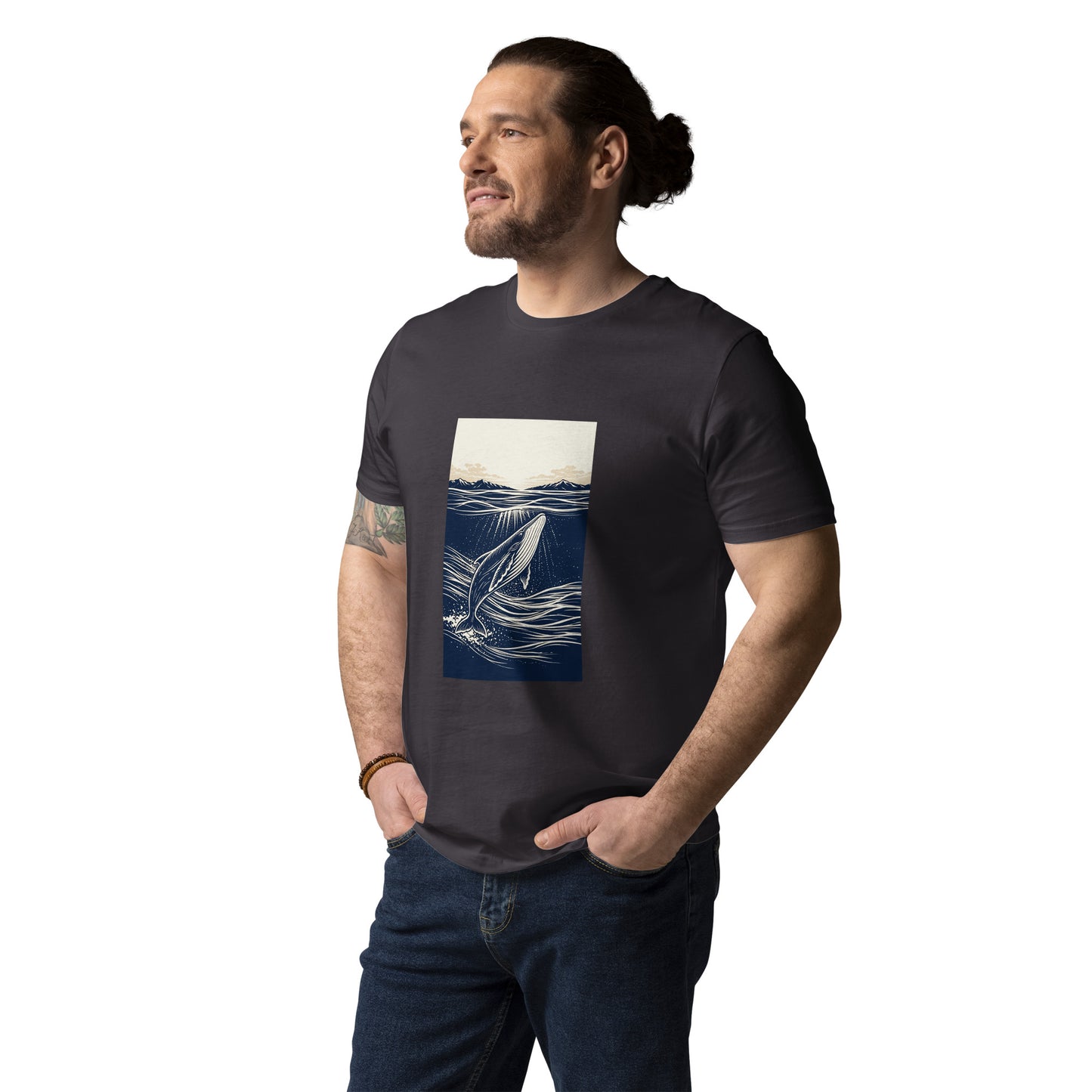 Lifestyle photo of Organic cotton whale graphic t shirt featuring a minimalist ocean illustration with rising whale and beige horizon sky. color: anthracite
