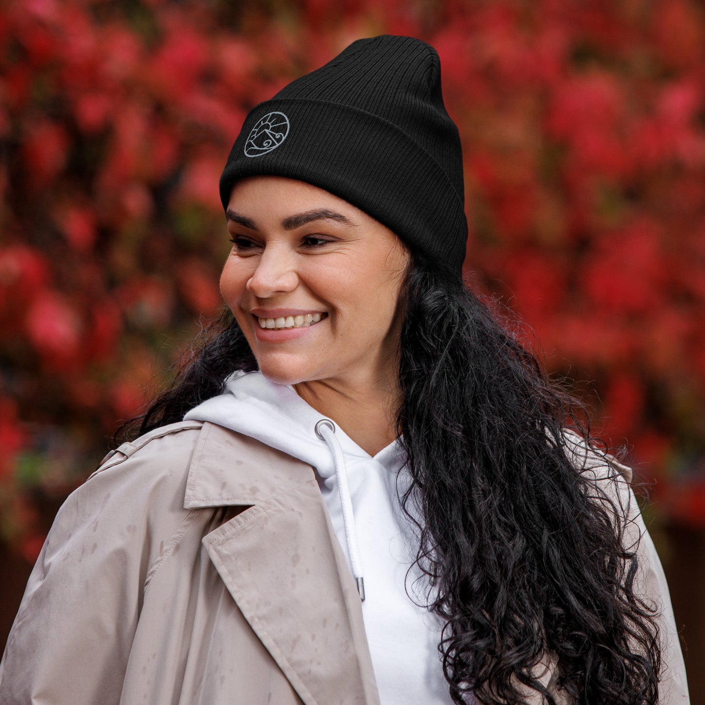 Lifestyle photo of organic ribbed beanie with subtle embroidered Gaia’s Harmony logo – unisex beanie – color: black