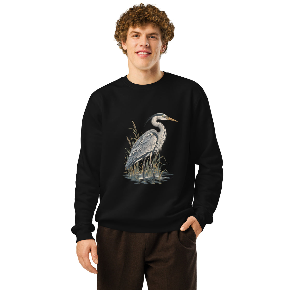 Lifestyle photo of a man wearing a black organic cotton sweatshirt with Grey Heron illustration designed by Gaia's Harmony. Color: black