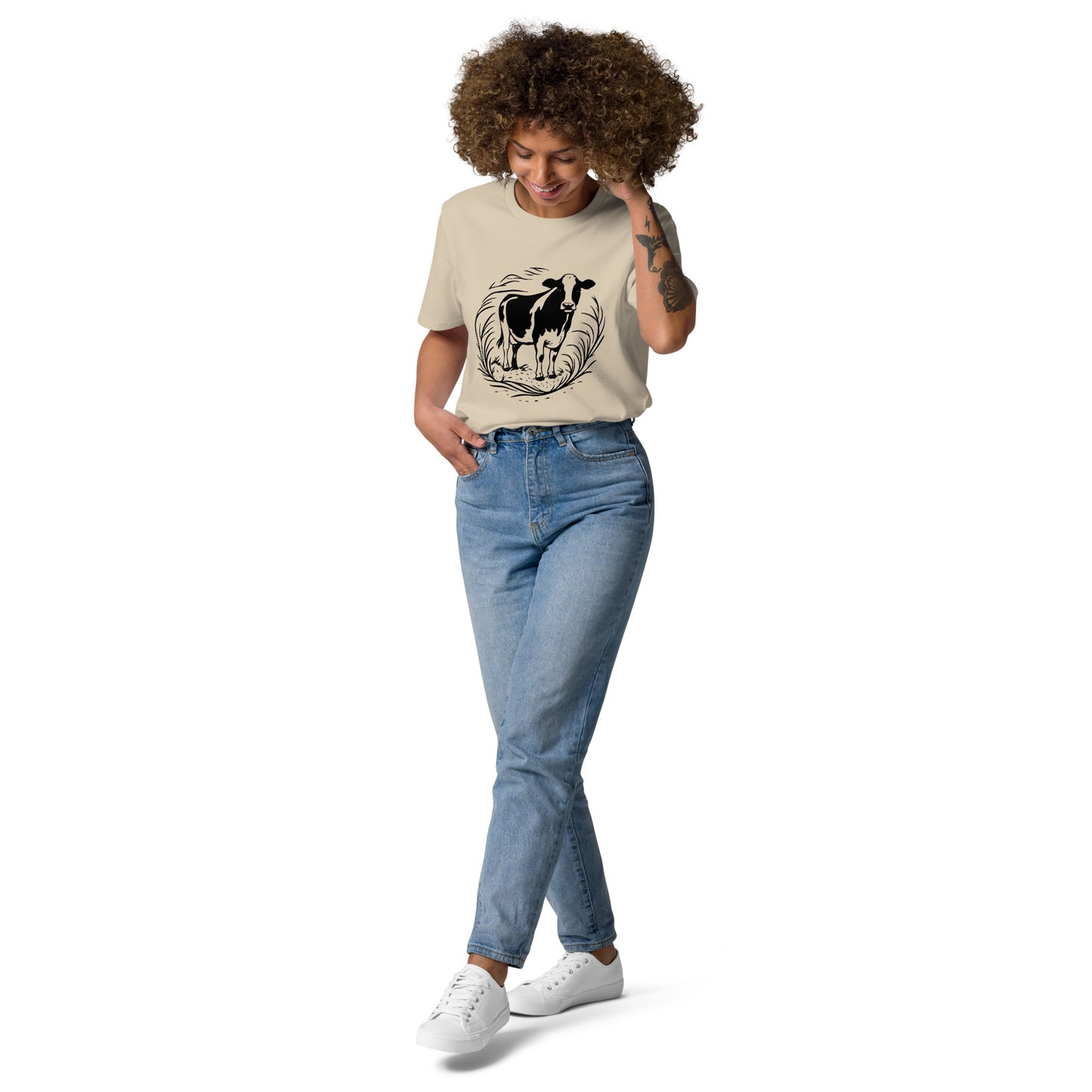 Lifestyle photo of Moving Forward organic cotton T-shirt with cow illustration – unisex tee – color: desert dust