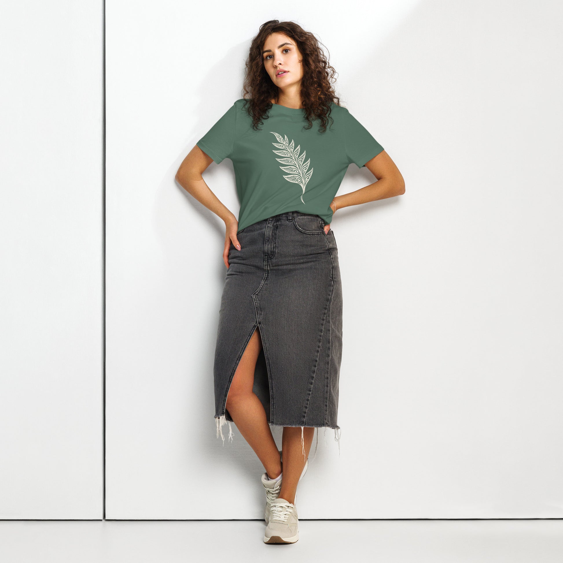Lifestyle photo of Organic green unisex T-shirt featuring an intricate white line art fern frond inspired by the woodlands of West Cork - color: green bay