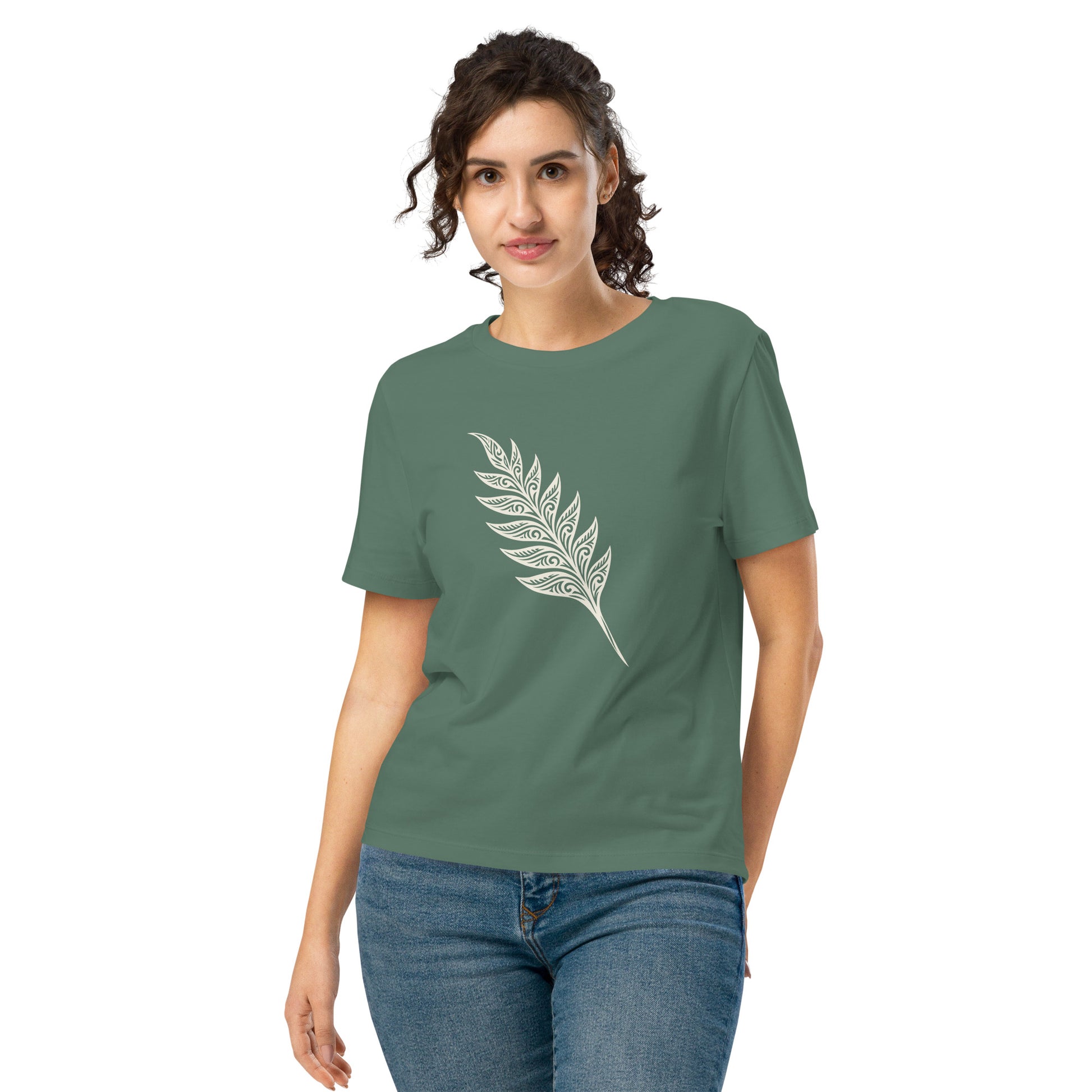 Lifestyle photo of Organic green unisex T-shirt featuring an intricate white line art fern frond inspired by the woodlands of West Cork - color: green bay