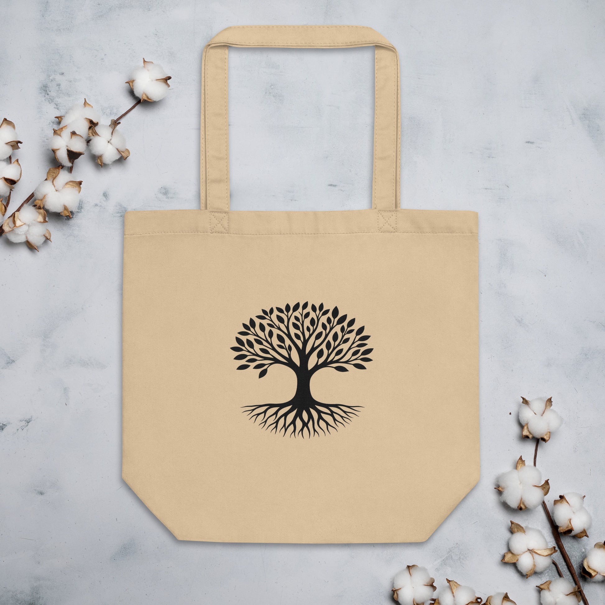 Front view of Tree of Life organic cotton tote bag in natural beige with black rooted tree graphic centered on front