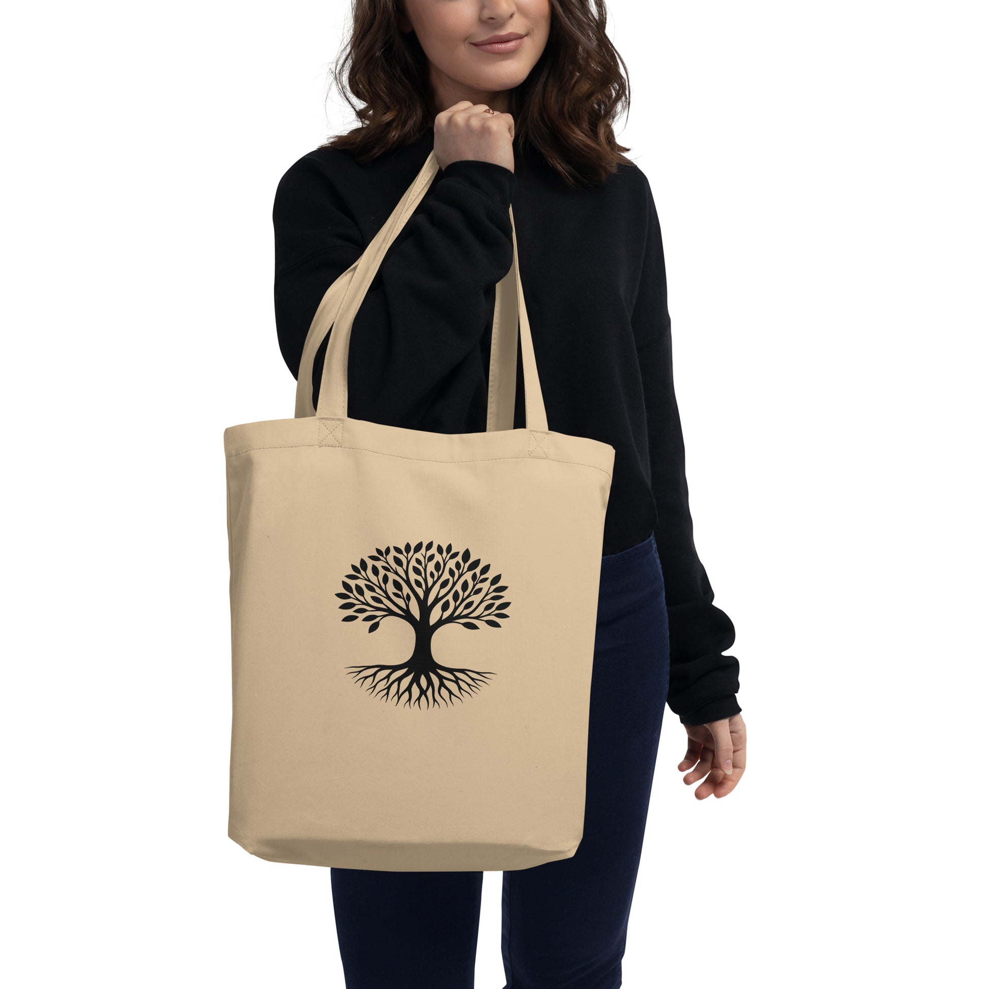 Lifestyle photo of Tree of Life organic cotton tote bag in natural beige with black rooted tree graphic centered on front